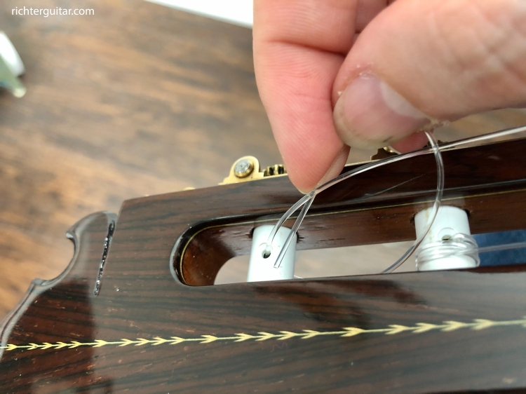 threading string back through classical guitar tuner hole