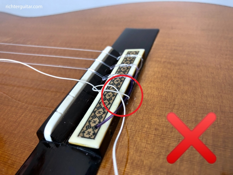 Incorrect way of tying classical guitar string at the bridge